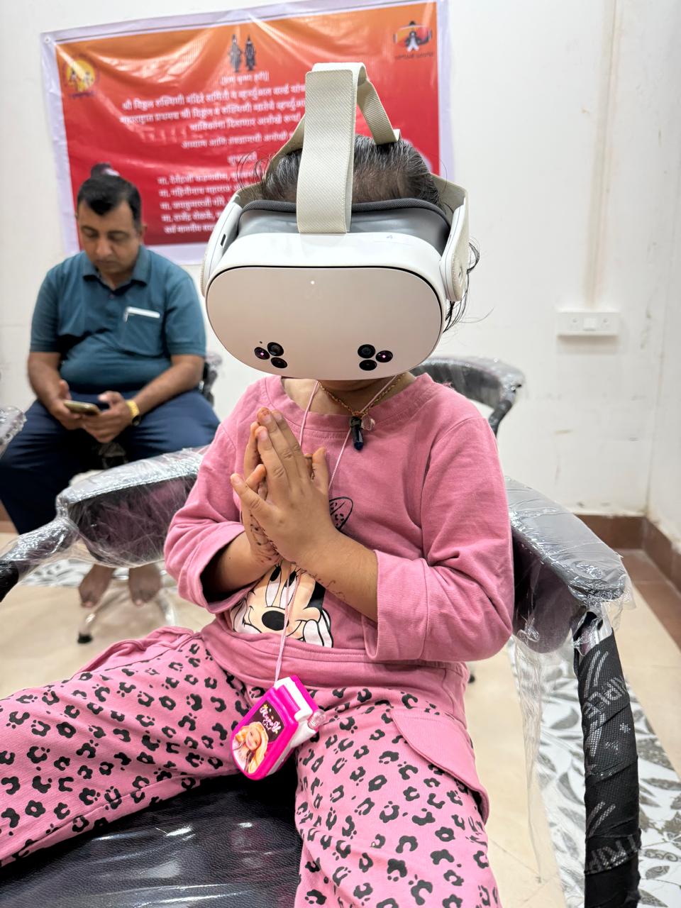 Young devotee in prayer during VR Darshan